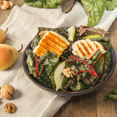 KI-generierte Beschreibung: Hauptinhalt: Frischer Salat mit gerösteten Kürbiskernen und Kürbisstücken.